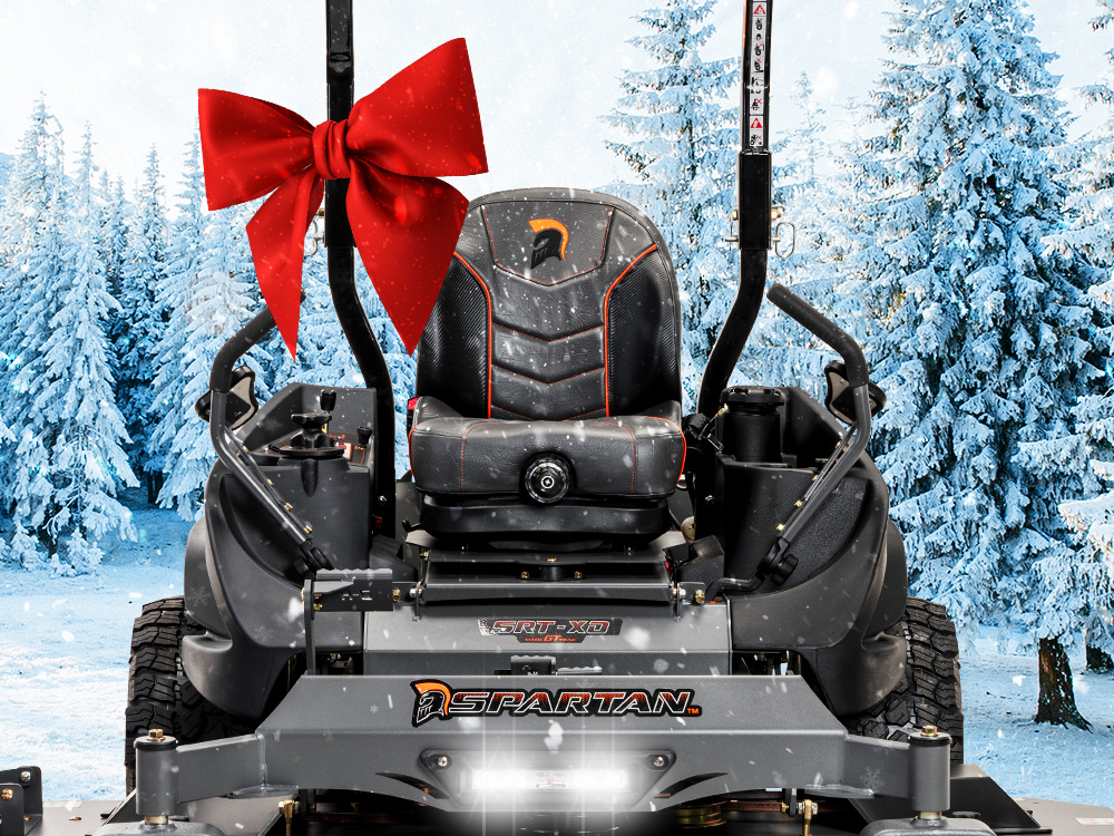 Spartan mower in snow with big red bow attached