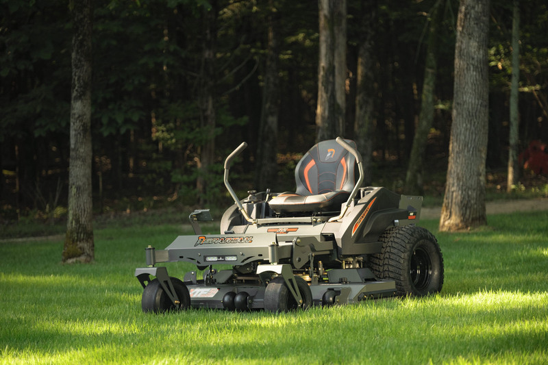 RZ mower parked in grass with trees in background